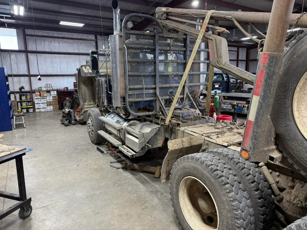 Logging truck inside workshop at local truck repair shop Mena AR for maintenance service